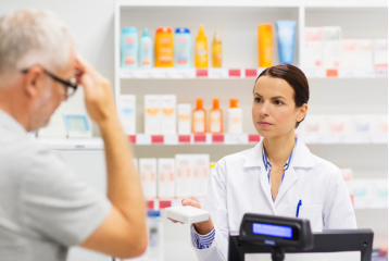 Farmacéutica sirviendo atención farmacéutica a un cliente